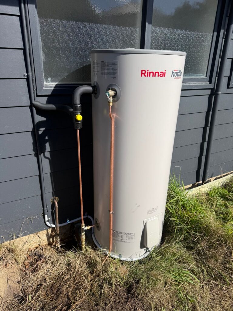 Rinnai Hotflo electric storage hot water system installed beside a home in the Southern Highlands